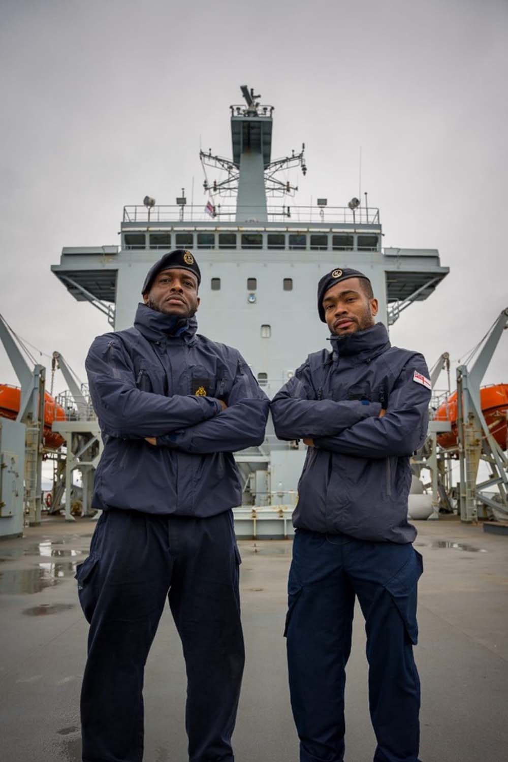 Two Royal Navy sailors gather supplies for devastated islanders